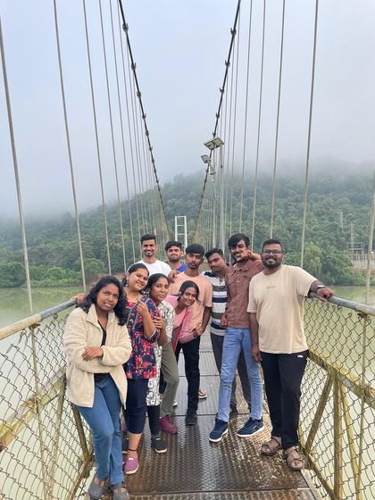 Posing on the misty suspension bridge during an early morning visit on our Gokarna trip.
