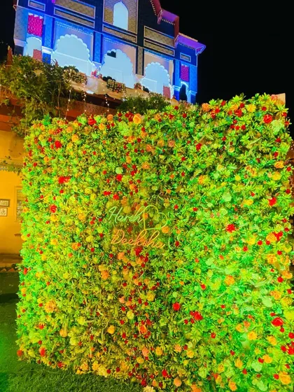 A beautiful floral wall with a custom neon sign, perfect as a photo backdrop for any wedding event.