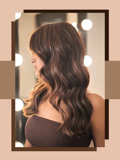 A side view of the chocolate brown hair, set against a backdrop of vanity lights. This angle highlights the shine and depth of the colour.