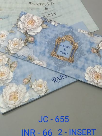 This invitation features a beautiful print of white peonies on a soft blue, textured background. The design is romantic and elegant, perfect for a classic wedding.