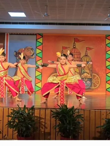 Young students performing a choreographed Chhau piece on stage. We train our students for real stage opportunities, building their confidence and performance skills from an early age.