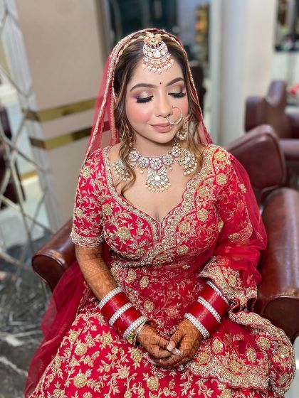 A close-up of the bride's makeup, with her eyes closed to show the soft, shimmery eyeshadow. This look is all about enhancing her natural beauty.