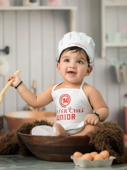 Introducing the Master Chef Junior. This creative themed portrait shows how we use playful setups and props, like a chef's hat and wooden utensils, to capture your baby's budding personality in a fun and unique way.