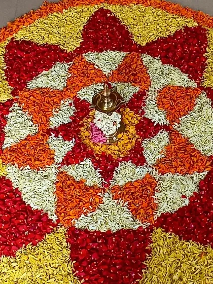 Art and culture come together in this beautiful Onam pookalam. Children learn about the harvest festival of Kerala by arranging flower petals, creating a stunning piece of collaborative art.