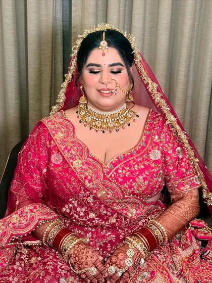 A moment of peace before the ceremony. The soft-focus eye makeup and perfectly blended base create a serene and beautiful bridal look.