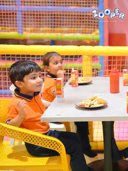 Two young guests enjoying their meal. Our café is designed to be kid-friendly and welcoming for families.