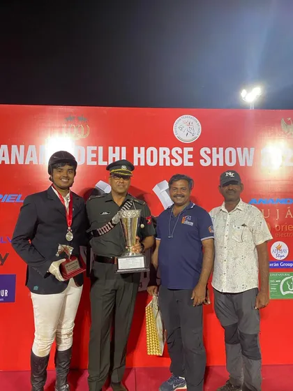 Our Best Young Rider award winner posing with his trophy and coaches. This award recognizes not just skill, but also horsemanship and sportsmanship.