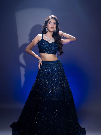 A full-length view of this glamorous evening look. The makeup is designed to stand out and complement the sparkle of the outfit.