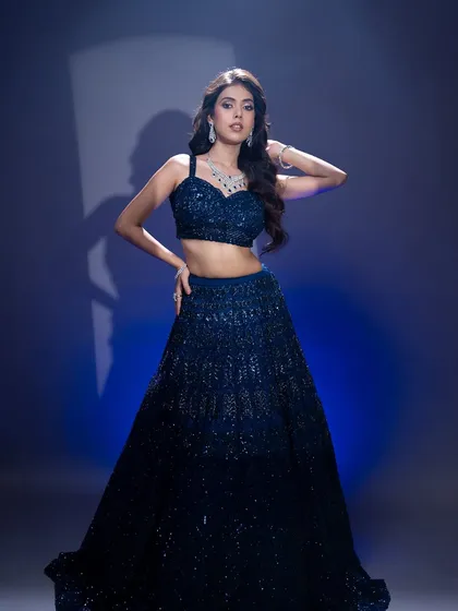A full-length view of this glamorous evening look. The makeup is designed to stand out and complement the sparkle of the outfit.