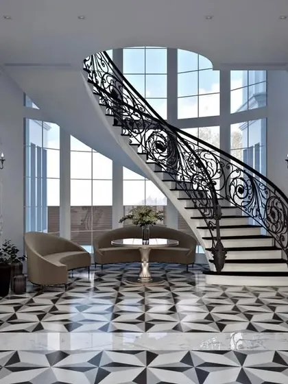 The magnificent foyer of the Chattarpur neo-classical bungalow, featuring a sweeping wrought-iron staircase. This entryway was designed to make a lasting first impression, highlighting our skill in creating dramatic spaces with custom details and high-end materials like geometric marble flooring.