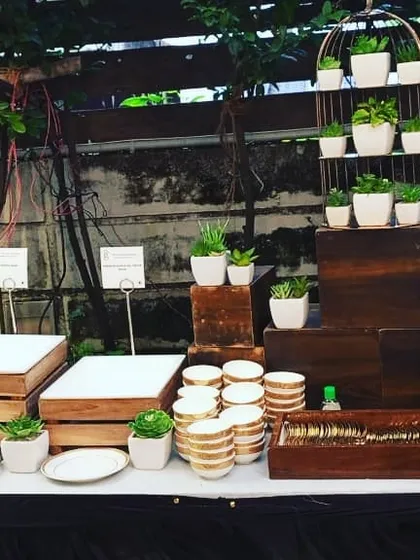 A rustic yet chic buffet station using wooden crates and potted succulents for decoration. This style is perfect for daytime events, garden parties, or eco conscious themes.