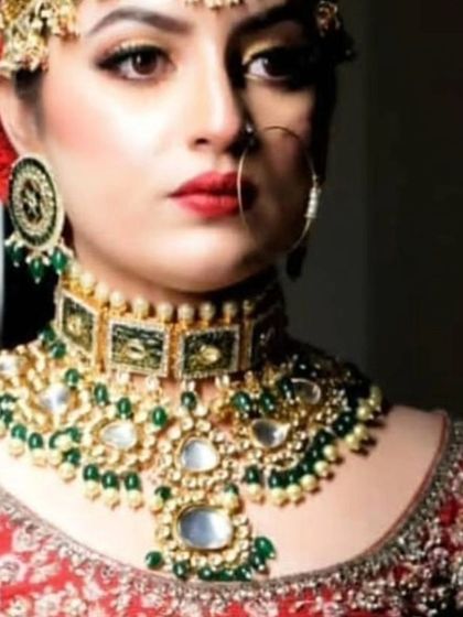 A close-up of a unique choker with green enamel and large uncut stones. This is a perfect piece for a bride looking for something special.