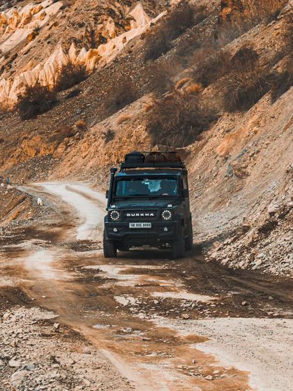 A Force Gurkha navigating the rough, unpaved roads of Spiti. This shot is perfect for adventure travel brands, showcasing the rugged capability of vehicles in extreme environments.