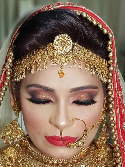 For this stunning Muslim bride, I created a dramatic smokey eye with a sharp wing and a bold red lip. The makeup was designed to stand out beautifully against her traditional red and gold Nikah attire.