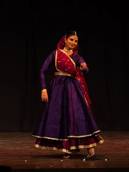 A moment of pure joy captured on stage. The vibrant purple costume and dynamic pose reflect the sheer happiness I feel while performing.