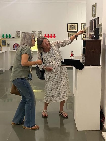 Artist Clare Arni in conversation with visitors at her exhibition.