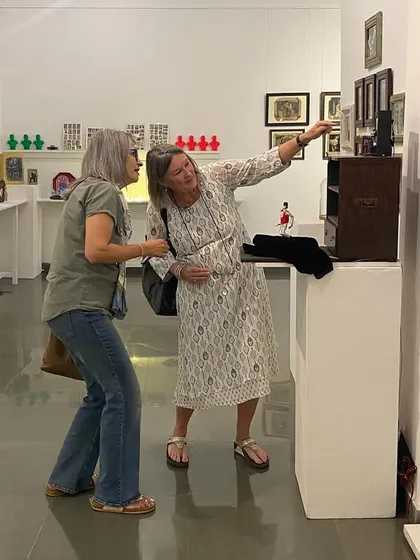 Artist Clare Arni in conversation with visitors at her exhibition.