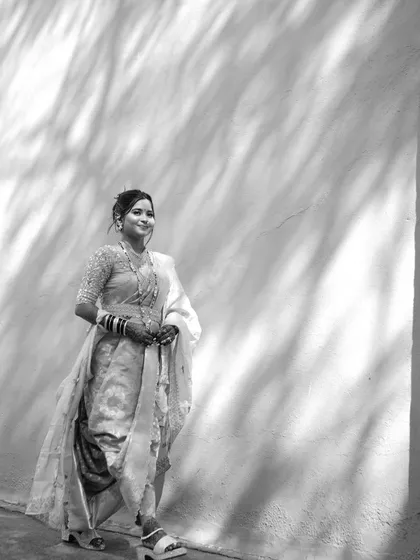 A timeless black and white portrait that emphasizes the classic silhouette and the bride's graceful posture.