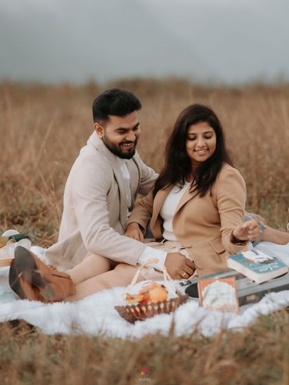 A cozy picnic setup in the hills of Chikmagalur. This shot combines the beauty of the Western Ghats with a fun, personal activity, making the pre-wedding shoot feel like a special date.