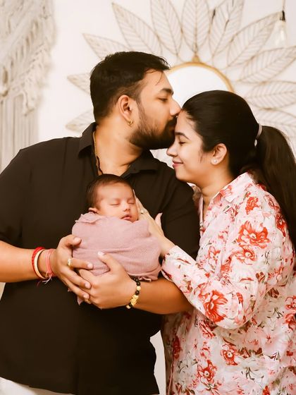 A father's gentle kiss for his sleeping baby. This is a portrait of pure love and protection, a beautiful moment captured forever during a newborn family session.