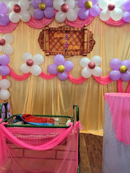 A clear view of the balloon flower backdrop, with a 'Guess My Name' sign adding to the excitement of the event.