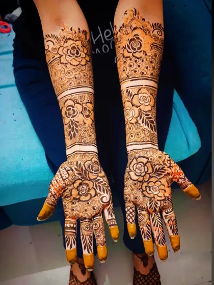 The same floral design with the henna paste still on, showing the precision of the application.