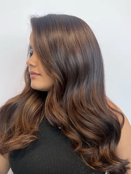 A side view of the completed balayage, showcasing the seamless blend of colors and the healthy shine of the hair after the service.