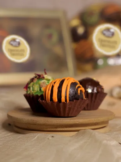 The chocolate orange truffle, with its vibrant orange drizzle, is a zesty and rich treat.