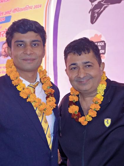 With a respected senior at a martial arts event. Learning from those who came before us is a core part of our tradition.