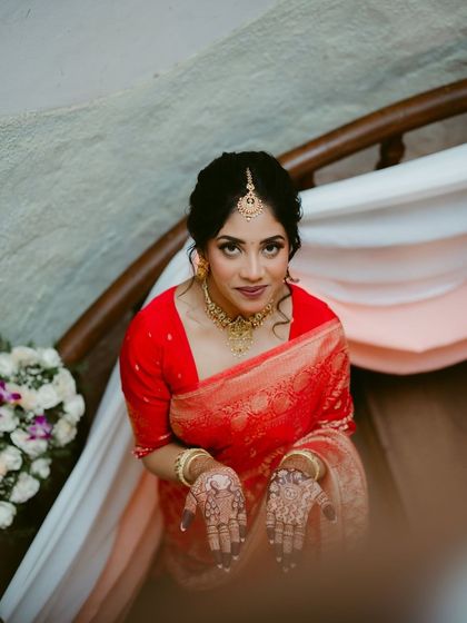 A beautiful bride showing her intricate henna-adorned hands. The high-angle shot provides a unique and lovely perspective.