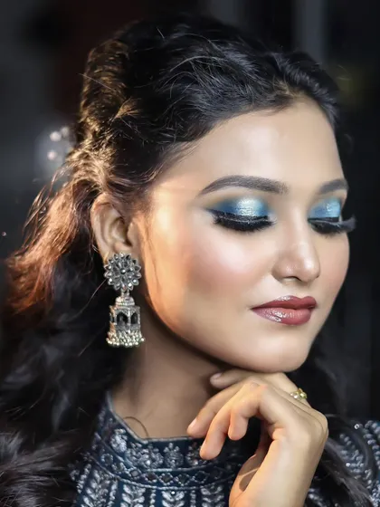 A dramatic blue smokey eye with a glossy lip. This look is perfect for an evening event and showcases advanced eyeshadow blending techniques.