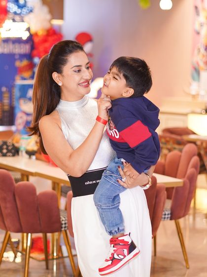 A mother sharing a sweet moment with her son at his third birthday party. Our comfortable and stylish cafe area is perfect for these quiet, personal interactions.