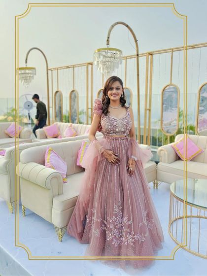 Our client looks absolutely radiant in this pink ruffled gown, perfect for an outdoor reception or engagement party. The style is both elegant and comfortable.