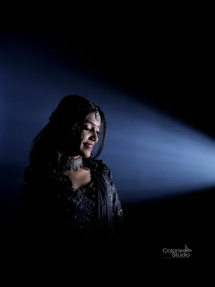 A dramatic, low-key portrait of the bride, using a single spotlight to create a moody and artistic feel.