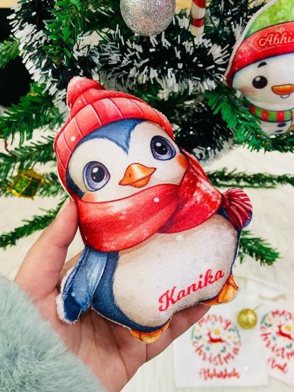Holding our cute penguin plush ornament. These are soft, kid-friendly, and make a wonderful holiday gift.
