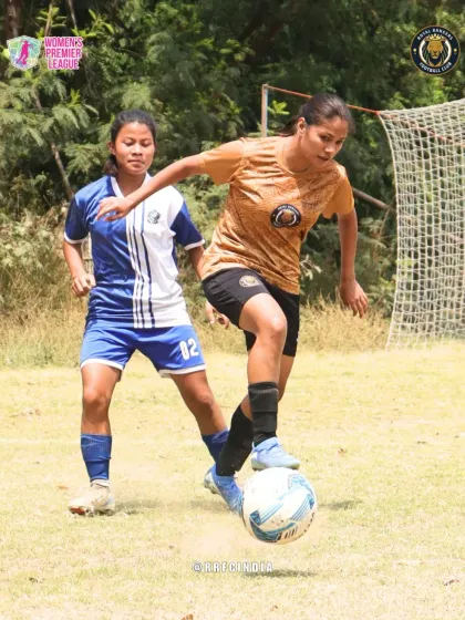 A dynamic shot of our player dribbling the ball while fending off a challenge from an opponent, highlighting her agility and ball control.