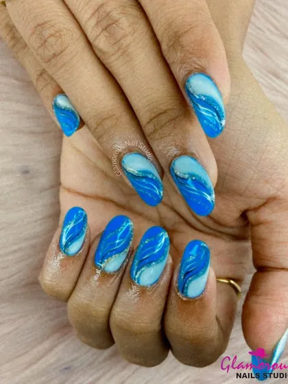 Making waves. This beautiful ocean-inspired design features mesmerizing swirls of light and dark blue, with a hint of silver glitter for a touch of sparkle.