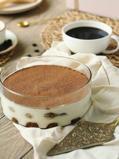 My Classic Tiramisu served alongside a cup of black coffee, highlighting the key flavor of this beloved Italian dessert.
