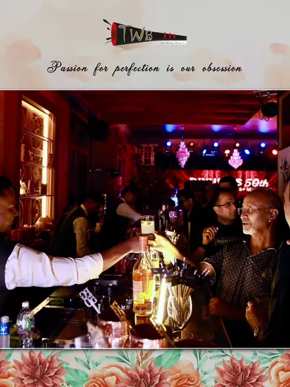 A bartender serves shots to guests at the bar, capturing the interactive and lively atmosphere of a 50th birthday celebration.