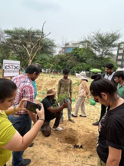 Our expert demonstrates the proper planting technique to a group of volunteers from Estee Advisors at Aravali Creek, ensuring every sapling gets a strong start.