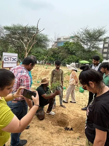 Our expert demonstrates the proper planting technique to a group of volunteers from Estee Advisors at Aravali Creek, ensuring every sapling gets a strong start.