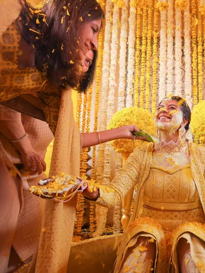 A tender moment between the bride and a family member during the Haldi ceremony, full of love and tradition.