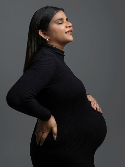 Soaking in every moment. This side profile captures the serene and powerful feeling of pregnancy, with the simple black dress and grey backdrop keeping the focus entirely on the mama-to-be.