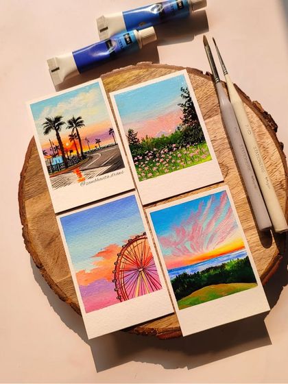 A closer look at some of my customized polaroid paintings. I use acrylics to create these vibrant sunset scenes, from palm tree-lined roads to colorful Ferris wheels. Each one is a little painted memory.