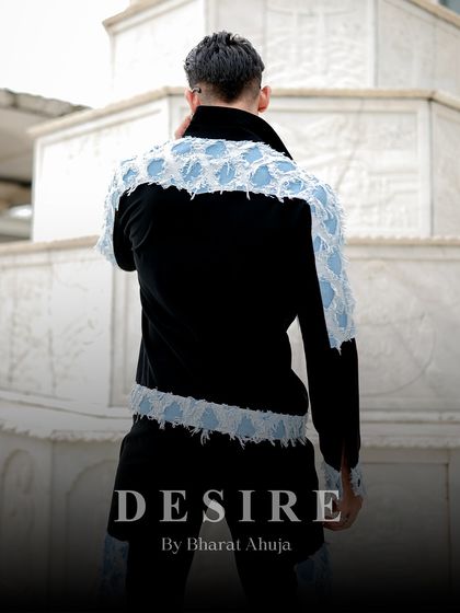 The back view of the denim patchwork jacket, showing the western-style yoke and the continuation of the distressed denim panels.