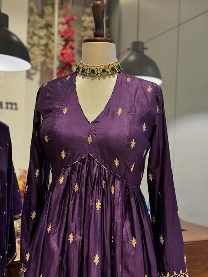 A close-up of a purple Anarkali with delicate gold buti embroidery, a timeless and elegant choice.