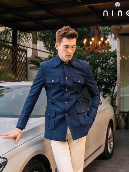 The navy safari jacket, styled with a car, exuding an aura of adventure and luxury.