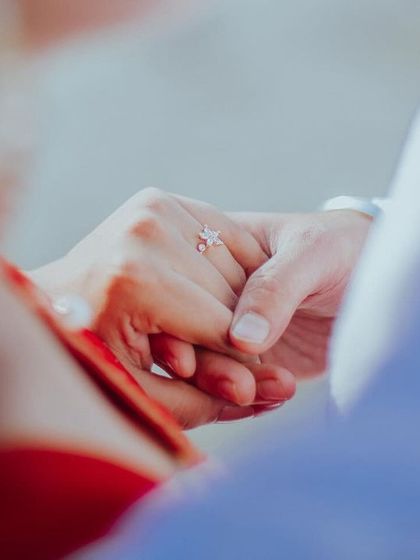 A detail shot of the couple holding hands during their pre-wedding session. This simple, symbolic gesture of connection and promise is a powerful part of their love story.