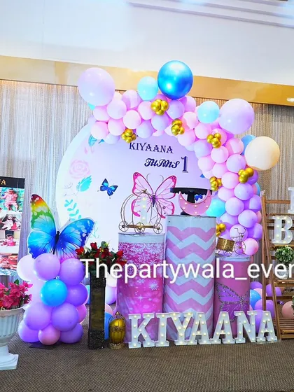 Another view of the butterfly party, showing the full balloon arrangement and the different props used to create a magical scene.
