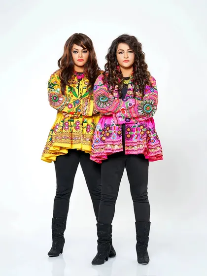 Our style is a reflection of our music: vibrant, traditional, and full of life. We carefully select our outfits for every performance, like these colorful jackets, to match the festive mood and celebrate our culture.